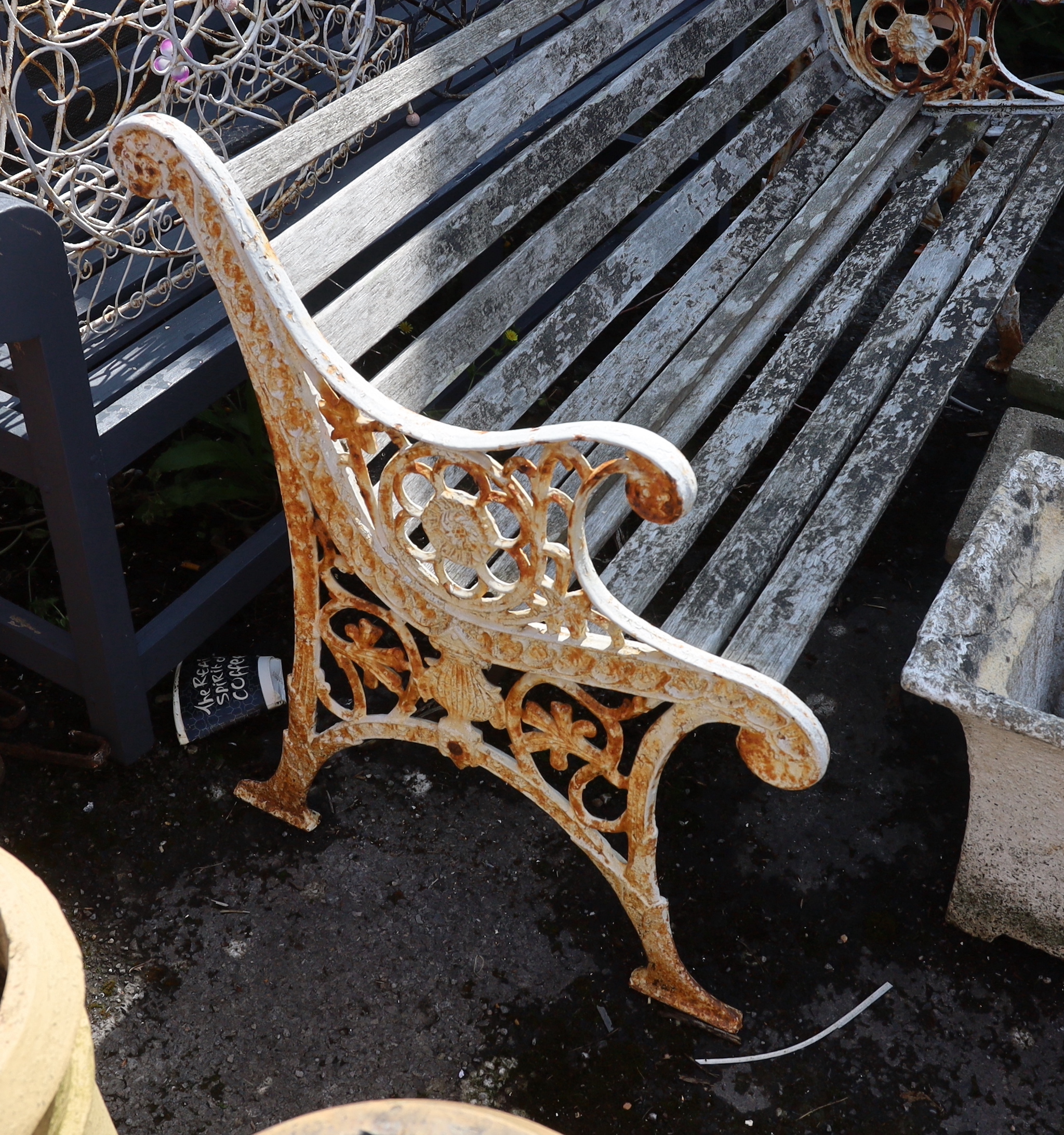 A Victorian style painted cast iron slatted garden bench, length 128cm, depth 68cm, height 78cm